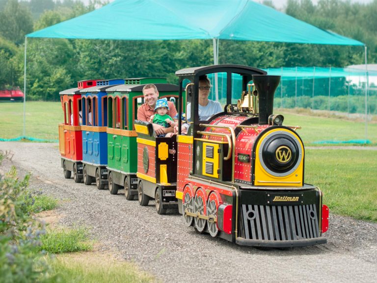 Campers riding the berry train at Kustermans Summer Camp