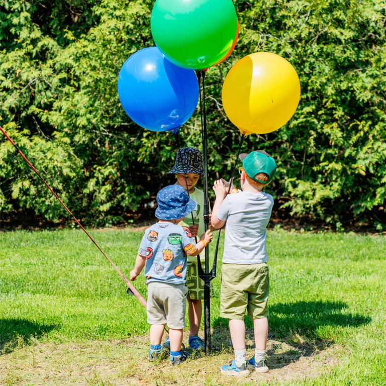 Colourful balloon arch decorating an outdoor birthday party at Kustermans Farm
