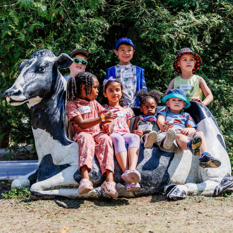 Family posing at a farm-themed photo booth during a birthday party at Kustermans