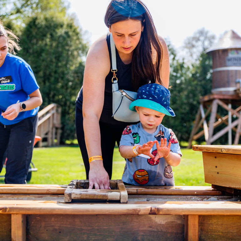 Mom and child playing games together at a Kustermans Farm birthday party