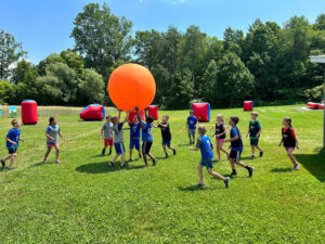 Kids playing kin-ball on the soccer field at Kustermans summer camp