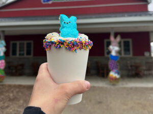 Colorful Easter treat cup topped with a blue Peeps marshmallow bunny and sprinkles