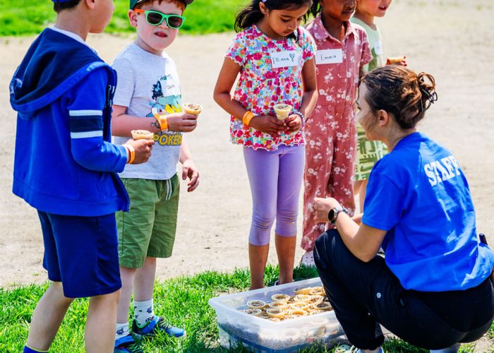 Visitors using animal cones to feed farm animals at Kustermans Adventure Farm