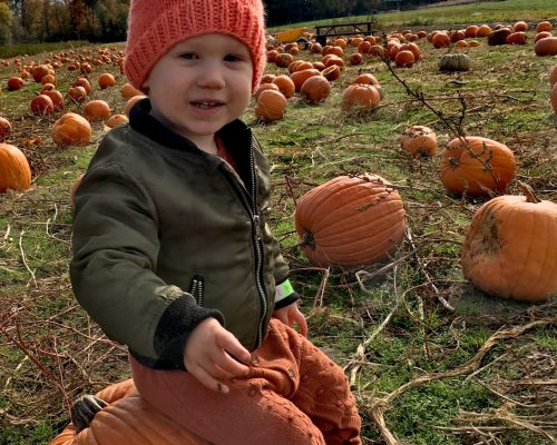 baby in pumpkin patch