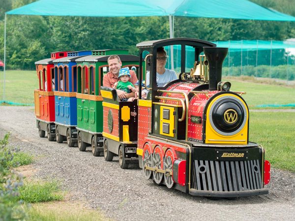 Visitors riding the Berry Express farm train at Kustermans Adventure Farm
