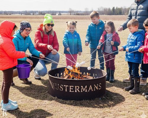 Families gathered around a campfire at the Kustermans fire pit area