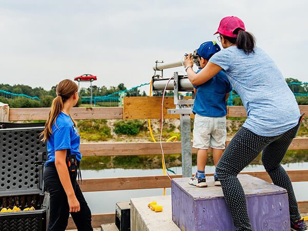 Child firing a corn cannon at targets at Kustermans Adventure Farm