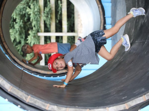 Child riding inside a giant human hamster wheel at Kustermans Hamster World