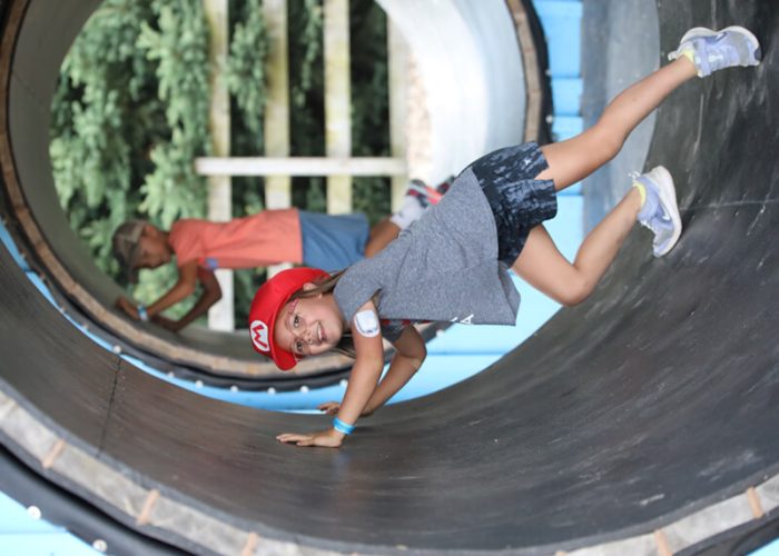 Child riding inside a giant human hamster wheel at Kustermans Hamster World