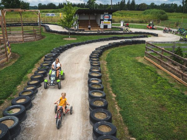 Go-karts racing around the Kustermans Speedway track at the adventure farm