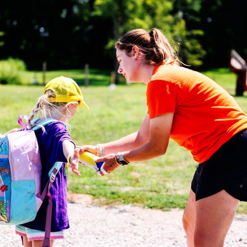 Summer Camp Safety at Kustermans Camp counsellor applying sunscreen to a young child at Kustermans summer camp