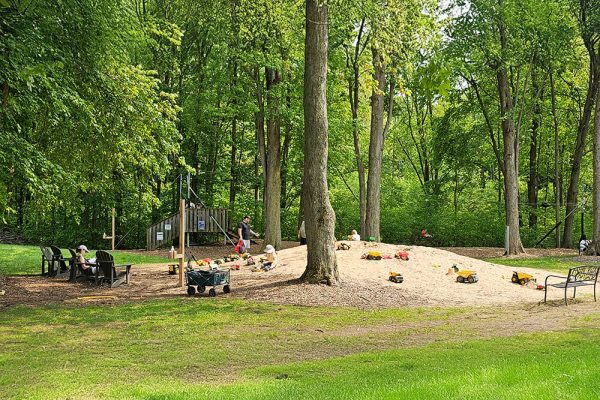 Children digging and building in the giant sand pile at Kustermans farm