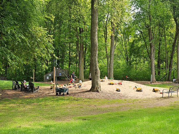 Children digging and building in the giant sand pile at Kustermans farm