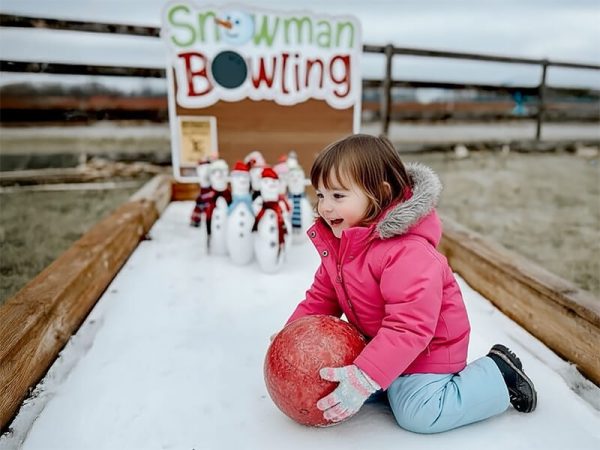 Children playing snowman bowling at the Kustermans Christmas event